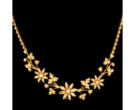 A Victorian pearl and yellow metal necklace, small seed pearls set in floral design clusters and foliage work, pendant loop t
