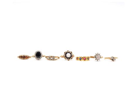 Seven gold gemset rings, two 9 carat yellow and white gold illusion set diamond two stone rings; an opal reverse cluster ring