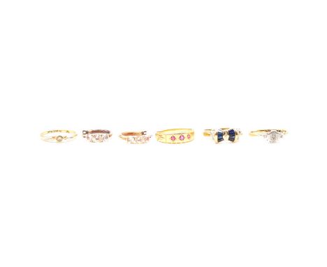 Four gold rings, a Victorian 18 carat yellow gold tapered band set with three pink stones, ring size N, Birmingham 1889, 2.9g