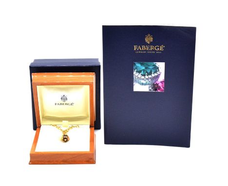 A Faberge Limited Edition enamel diamond set egg pendant, the yellow metal openwork frame egg with purple, green and terracot