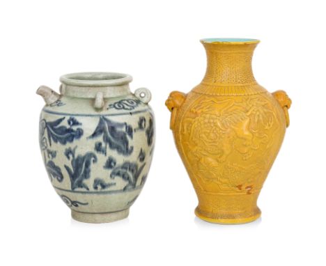 A YELLOW GROUND VASE AND A BLUE AND WHITE WINE EWER
Baluster vase with moulded decoration of foo lions, beast lug mounts at s