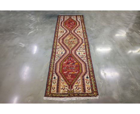 A CAUCASIAN 'KIS' KILIM RUNNER 290 x 100cm
Handwoven wool with a triple medallion design framed by a geometric border, decora