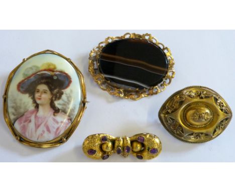 A Victorian garnet brooch, converted from a pair of earrings, an agate brooch, a portrait brooch and a panel brooch (4)