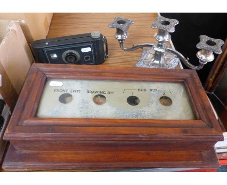 An early 20th century bell indicator board, folding camera and plated candelabra