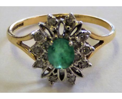 A 9ct gold emerald and diamond cluster ring claw set with a mixed cut stone bordered by single cuts