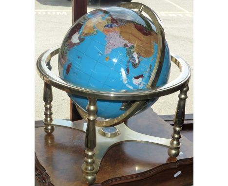 A gemstone globe on a gilt metal stand, these handcrafted globes use 40 different minerals and semi-precious stones to depict