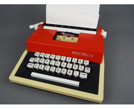 Petite International - A Petite International Deluxe toy typewriter in a hard carry case. The item appears to be in Near Mint