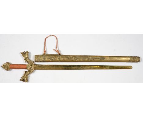 A CHINESE ORNAMENTAL BRASS PRESENTATION SWORD AND SCABBARD WITH CAST DRAGON QUILLONS, BLADE ENGRAVED WITH PRESENTATION INSCRI