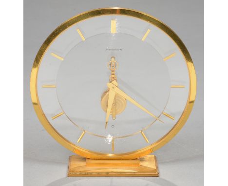 A JAEGER LECOULTRE ROUND GILT BRASS AND LUCITE SKELETON BAGUETTE EIGHT DAY TIMEPIECE, 19CM H Good condition with only light h