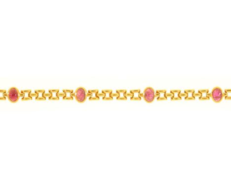 A GOLD BRACELET WITH RUBY CABOCHONS AT INTERVALS, APPROXIMATELY 160MM, MARKED 375, 12.8G  Good condition