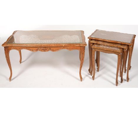 A CARVED LIGHT WOOD COFFEE TABLE WITH GLASS TOP, 50CM H; 100 X 54CM AND A NEST OF THREE SIMILAR OAK TABLES, 51CM H; 55 X 37CM