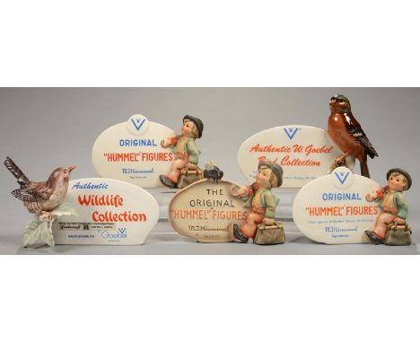ADVERTING. FIVE W. GOEBEL EARTHENWARE RETAILER'S CABINET STANDS COMPRISING THREE INCORPORATING A HUMMEL FIGURE, 9-11CM H, PRI