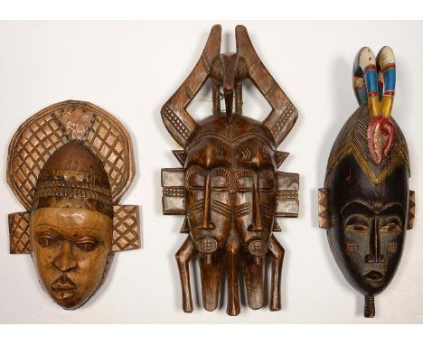 TRIBAL ART. THREE AFRICAN CARVED WOOD MASKS, ONE APPLIED WITH SHEET COPPER HEADDRESS, POLYCHROME PAINTED EXAMPLE LABELLED IVO