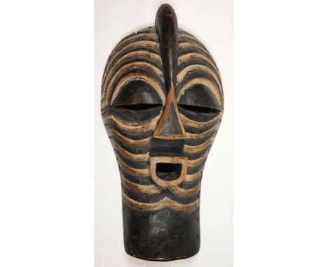 TRIBAL ART. A SONGYE KIFWEBE (STRIATED) MASK WITH GEOMETRIC PIGMENT DECORATION, 45CM H  Some wear, shrinkage crack at top; du