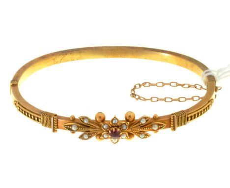 A LATE VICTORIAN OR EDWARDIAN RUBY AND CULTURED PEARL SET GOLD BANGLE WITH CENTRAL CLUSTER, 59MM, MARKED 15C, 7.4G  Good cond
