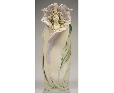 AN ART NOUVEAU ROYAL DUX IRIDESCENT GLAZED PORCELAIN VASE IN THE FORM OF THE HEAD OF A GIRL EMERGING FROM A LILY, 33CM H, MAR