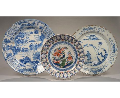 A DUTCH DELFT WARE CHINOISERIE CHARGER, PAINTED WITH A SOLITARY ANGLER STANDING WITH ROD IN HAND&nbsp; IN A LANDSCAPE, THE BO