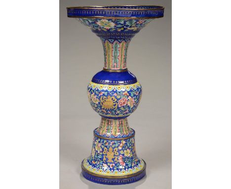 A CANTON ENAMEL GU VASE, PAINTED IN A BRIGHT FAMILLE ROSE PALETTE IN THREE REGISTERS WITH LOTUS MEANDER AND AUSPICIOUS EMBLEM