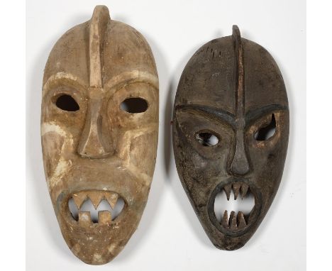 TRIBAL ART. TWO CARVED WOOD MASKS, PROBABLY BORNEO, ONE WITH PAINTED DECORATION, 27 AND 30CM  Smaller mask with small chip at