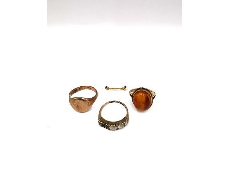 A collection of three 9ct yellow gold rings, including a 9ct ring sizer,an amber and 9ct yellow gold dress ring and a 9ct sig