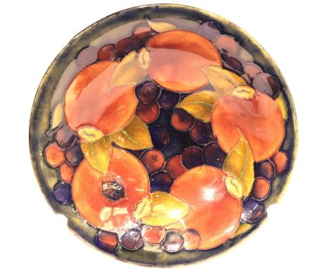 A Moorcroft shallow circular bowl in the Pomegranate pattern, D: 16 cm, signed to base. Rim slightly off circular suggesting 