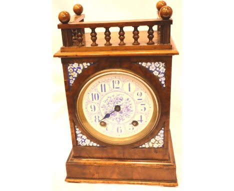 An Edwardian walnut cased mantel clock with enamelled circular dial, chiming on a gong, H: 32 cm. Working at lotting. P&amp;P