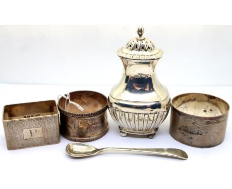 Three silver napkin rings, a silver mustard spoon and a silver pepper pot hallmarked Chester, combined 146g. P&amp;P Group 2 