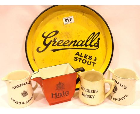 Antique metal and enamel circular Greenalls drinks tray and four antique water jugs. Gilt rubbed/worn on Greenalls jugs, othe