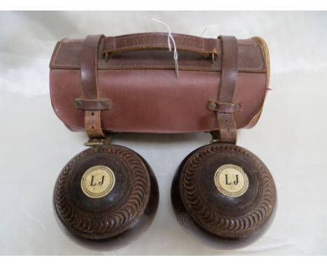 2x Vintage bowls / woods in leather carry case. Initialled with 'L J'.