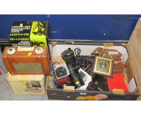 A tray of vintage cameras and lenses together with a projector, screen, tripod, Bakelite electric clock, and headphones