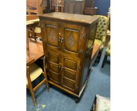A carved oak drinks cabinet 