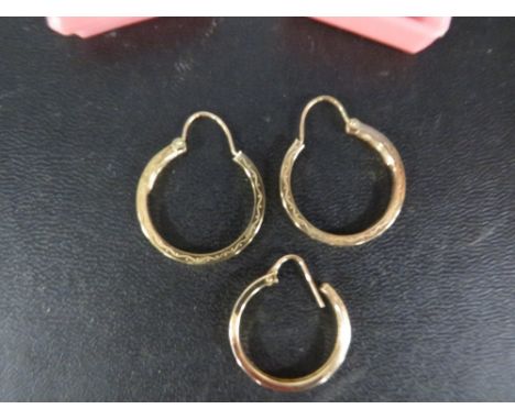 A pair of yellow metal hoop earrings stamped 375 approx 1.9g together with an unmarked yellow metal earring 