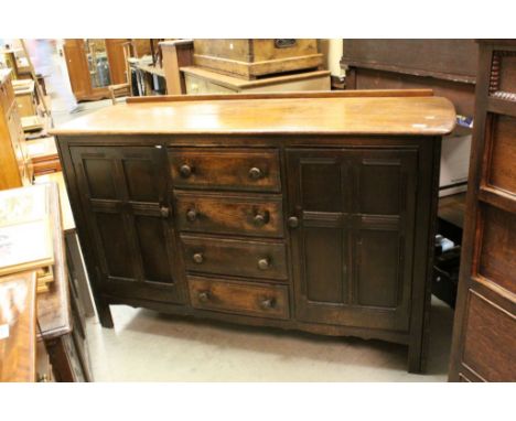 Ercol Dark Oak Sideboard with four central drawers flanked by cupboard doors either side