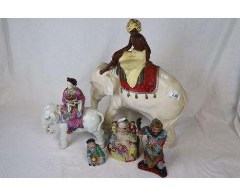 Four Oriental ceramic figures and a large painted Plaster Elephant with seated figure
