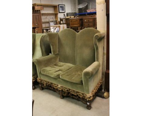 Carved Oak Framed & Green Upholstered Two Seater Sofa in the late 17th century Style, a high double arched back,scroll carved