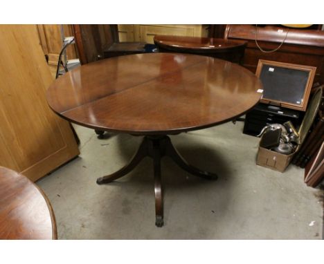 Reproduction Regency Extending Dining Table with additional leaf raised on a central column with four splay legs and brass pa