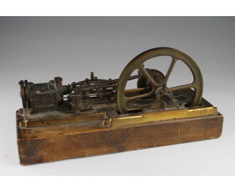 Live steam stationary engine with single flywheel, mounted on a wooden plinth, total height 16.5cm approx., length 34cm appro