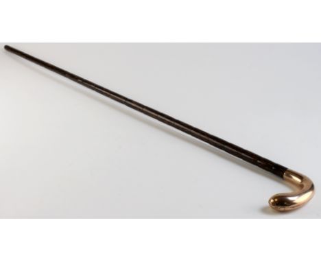 Edwardian malacca walking stick / cane, with curved 9ct gold handle. engraved with the initials 'H. W.', hallmarked 'London 1