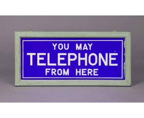 A vintage blue &amp; white glass sign “You May Telephone From Here”, in painted wooden frame, 9” x 18” over-all.