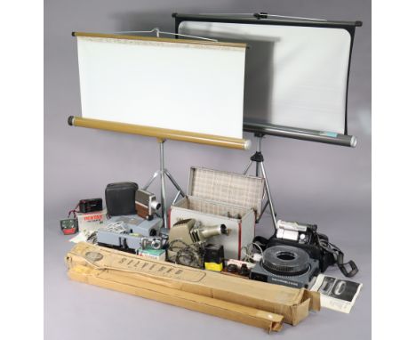 An Aldis film projector; two slide projectors; three projector screens; a movie camera, etc.