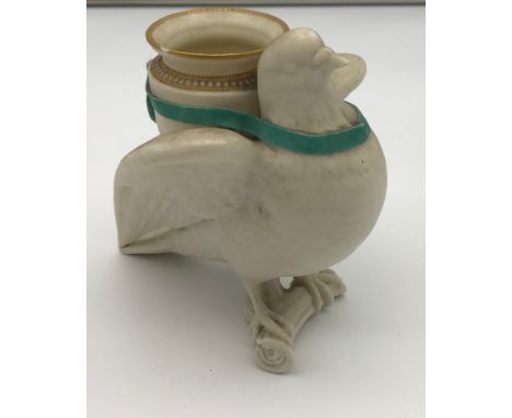 A 19th century porcelain Royal Worcester Dove vase. A Dove standing upon a branch, holding and urn on its back with a blue ri