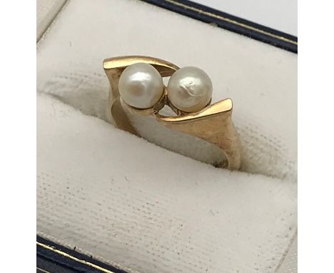 A Ladies 9ct yellow gold and two pearl set ring. [Ring size] [3.82Grams] 