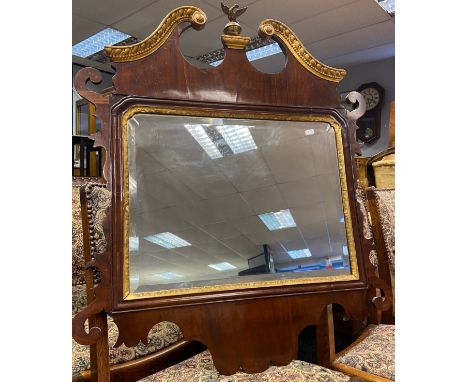 A Regency wall mirror designed with scroll edge, painted gilt trims and eagle finial. [89x76cm] 
