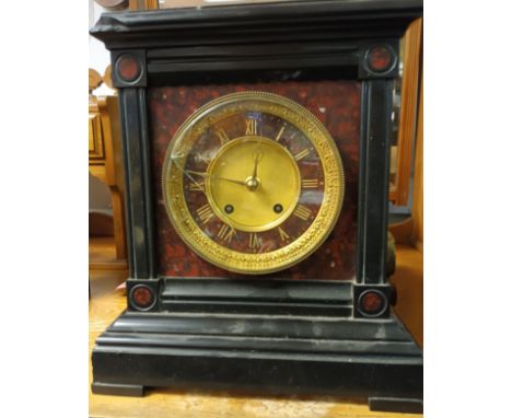 Antique slate mantle clock. Detailing brass face and roman numerals. 