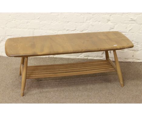 An Ercol Golden Dawn light oak coffee table with magazine storage shelf.