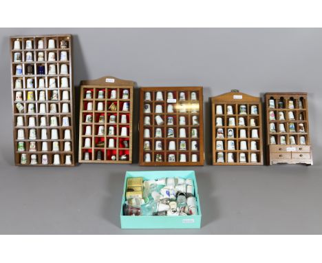A good collection of ceramic thimbles mounted in display cases.
