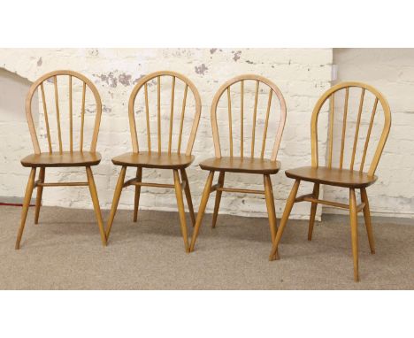 An Ercol set of four light oak spindleback chairs.