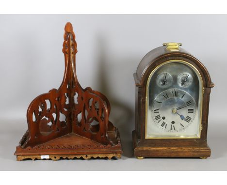 An oak cased dome topped Westminster bracket clock and associated mahogany bracket with silver dial and housing a three train