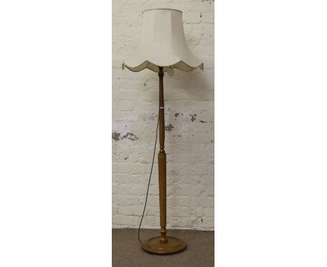 A turned and reeded standard lamp with shade.