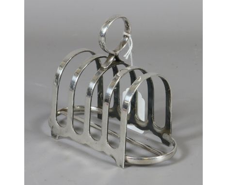 A silver plate four section toast rack with military arrow head stamp and date 1957 possibly officers mess.
